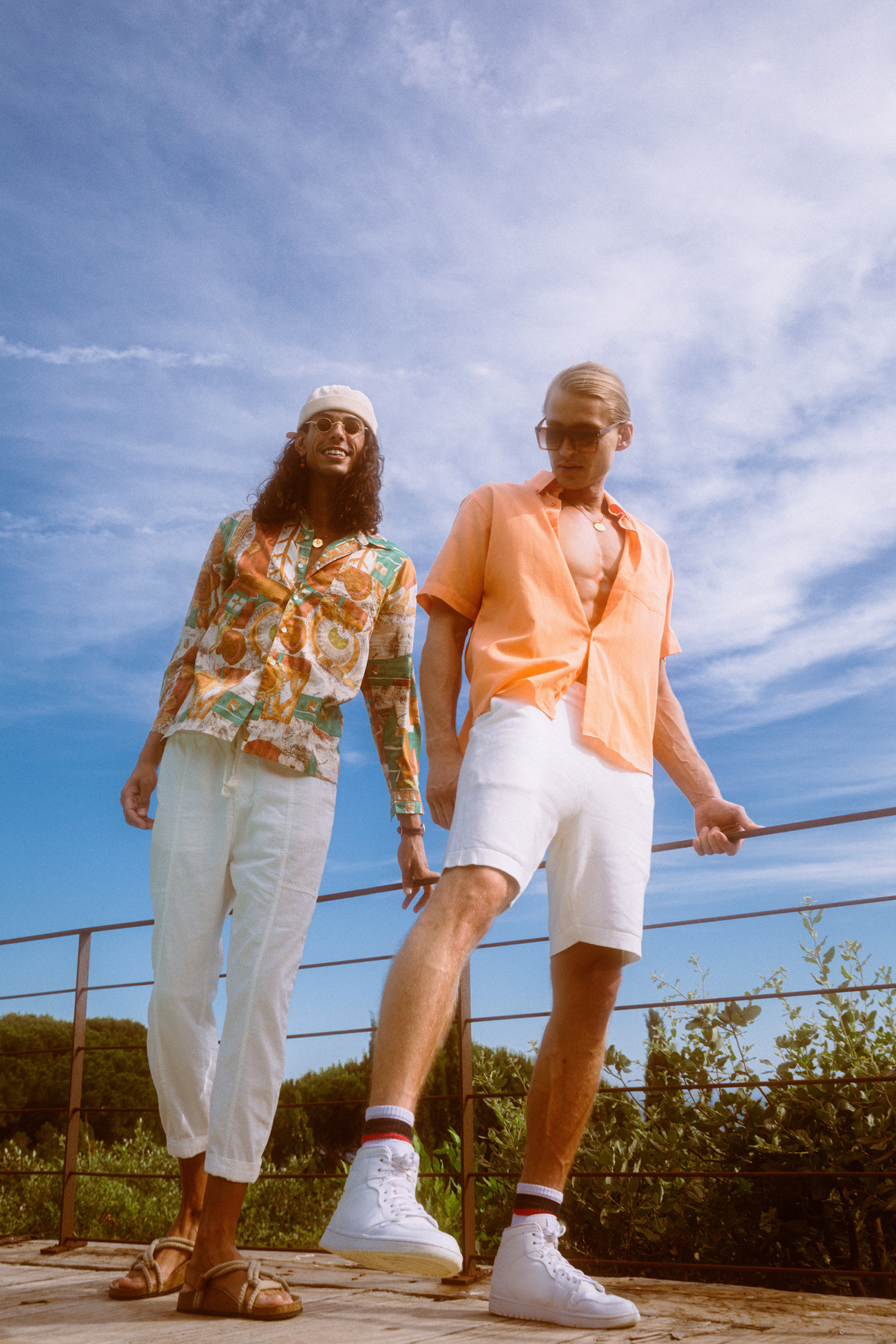 two individuals wearing orange tropical shirts